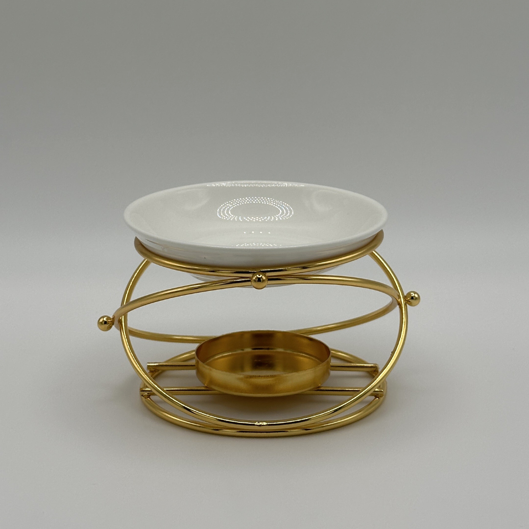 White ceramic wax melt burner on gold stand with small dish, ideal for matte black home fragrance